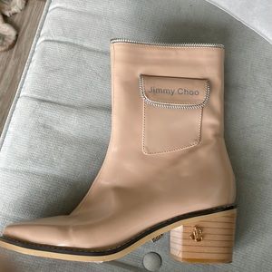 Tan leather boots with silver zippers and gold emblem. Never worn Size 8
